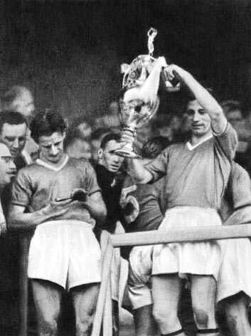 1957, Dennis admires medal whilst Roger Byrne lifts the trophy