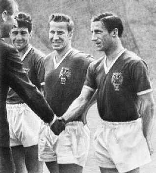 1958, Dennis shakes hands with the Duke of Edinburg with Bobby Charlton looking on
